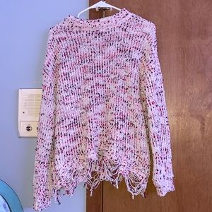 Multicolored sweater with distressed ends.